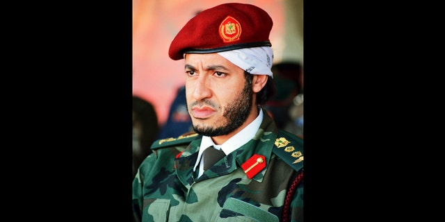 FILE - In this undated file photo made available on Sunday Sept. 25, 2011, al-Saadi Gadhafi, son of the late Libyan leader Moammar Gadhafi, watches a military exercise by the elite military unit commanded by his brother, Khamis, in Zlitan, Libya. Mexican prosecutors say they broke up not one, but two Indiana Jones-style plots to "extract" the son of late Libyan dictator Moammar Gadhafi from Libya as his father's regime crumbled. Mexico's Assistant Attorney General Jose Cuitlahuac Salinas says the plan to bring al-Saadi Gadhafi to Mexico involved piles of stolen passports, white-knuckle flights with pilots who refused to land in war-torn Libya and luxury homes bought under false names in Mexico. (AP Photo/Abdel Magid al-Fergany, File)