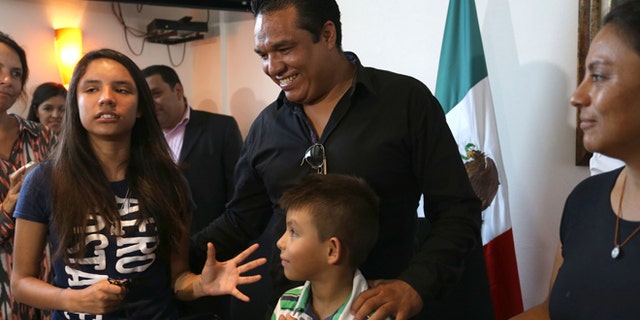 Alondra Luna Nunez, left, gets up after giving a press conference with her parents Gustavo Luna and Susana Nunez after landing at the Guanajuato International Airport in Silao, Mexico, Wednesday, April 22, 2015. The 14-year-old Mexican girl, who was taken from her school by police and sent kicking and screaming to the U.S., returned home after DNA tests showed she is not related to an American woman searching for her missing daughter. There was no immediate explanation of why authorities did not confirm her identity before sending her out of the country. (AP Photo/Mario Armas)
