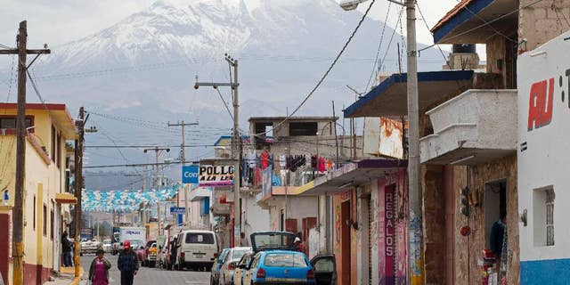 FILE - In this March 10, 2015 file photo, the Pico de Orizaba volcano rises above the town of Tlachichuca in Mexico's Puebla state. Mountaineers discovered another mummified body on Mexico’s tallest peak and brought it down on Thursday, June 4, 2015, making it the third body found in recent months. The body's identity was still being confirmed. (AP Photo/Rebecca Blackwell, File)