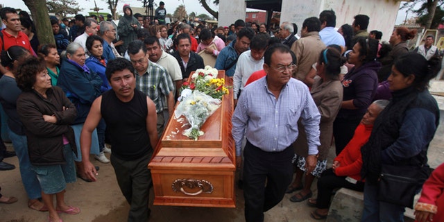 Relatives carry the coffin that contain the remains of slain journalist Gregorio Jiménez as they walk towards the cemetery in Coatzacoalcos, Mexico, Wednesday, Feb. 12, 2014. Veracruz state officials concluded that Jiménez, a police beat reporter, was killed in a personal vendetta, unrelated to his reporting. But journalists throughout Mexico are calling for a thorough investigation. Jimenez is the 12th journalist slain or gone missing since 2010 in the Gulf state of Veracruz. (AP Photo/Felix Marquez)