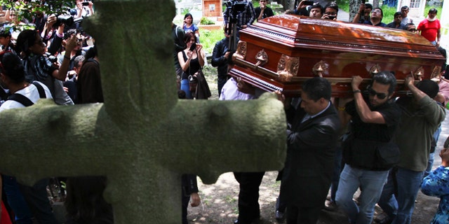 Men carry the casket of murdered photojournalist Rubén Espinosa during his funeral service in Mexico City, Monday, Aug. 3, 2015. With an investigation barely underway, Mexican journalist protection groups are already expressing fears that authorities won't consider Espinosa's brutal killing as being related to his work - even though he fled the state he covered fearing for his safety. Espinosa, 31, worked for the investigative magazine Proceso and other media in Veracruz state. (AP Photo/Marco Ugarte)