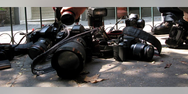 Photojournalists place their cameras on the floor during a demonstration condemning the alleged murder of fellow journalist Regina Martinez in Mexico City, Sunday April 29, 2012. The Mexican government's human rights commission said Sunday that it will investigate the apparent slaying of a correspondent for Proceso newsmagazine who often wrote about drug trafficking. Police found the body of Martinez on Saturday inside the bathroom of her home in the Veracruz state capital, Xalapa. (AP Photo/Marco Ugarte)