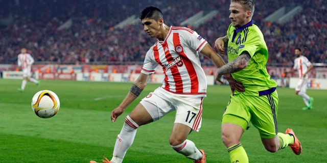 FILE - In this Thursday, Feb. 25, 2016 file photo, Olympiakos' Alan Pulido, left, fights for the ball with Anderlecht's Alexander Buttner during the Europa League round of 32 soccer match at the Georgios Karaiskakis stadium in the port of Piraeus, near Athens. A state official says that Mexican soccer star Alan Pulido has been kidnapped in the northern border state of Tamaulipas. Pulido is a forward for the Greek team Olympiacos and has made several appearances for Mexicos national team, though he wasnt called up for the upcoming Copa America tournament. The official says the 25-year-old player was kidnapped near his hometown of Ciudad Victoria on Sunday, May 29, 2016 after leaving a party. (AP Photo/Thanassis Stavrakis, file)