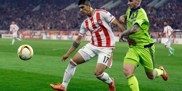 FILE - In this Thursday, Feb. 25, 2016 file photo, Olympiakos' Alan Pulido, left, fights for the ball with Anderlecht's Alexander Buttner during the Europa League round of 32 soccer match at the Georgios Karaiskakis stadium in the port of Piraeus, near Athens. A state official says that Mexican soccer star Alan Pulido has been kidnapped in the northern border state of Tamaulipas. Pulido is a forward for the Greek team Olympiacos and has made several appearances for Mexicos national team, though he wasnt called up for the upcoming Copa America tournament. The official says the 25-year-old player was kidnapped near his hometown of Ciudad Victoria on Sunday, May 29, 2016 after leaving a party. (AP Photo/Thanassis Stavrakis, file)