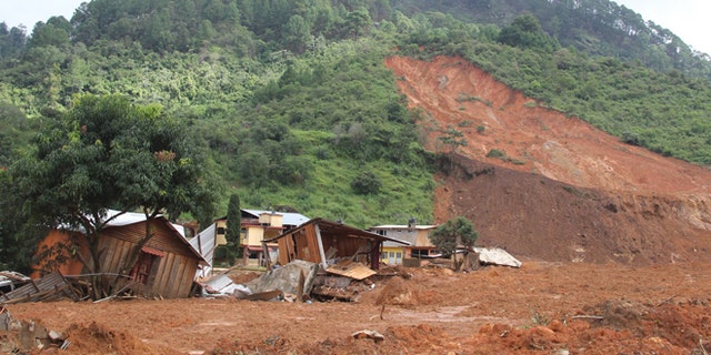 In this photo released by Mexico's Secretary of the Interior, structures lay in ruins at the site of a landslide in the village of La Pintada, Mexico, Thursday, Sept. 19, 2013. La Pintada was was affected by the twin paths of Tropical Storm Manuel and Hurricane Ingrid, which simultaneously pounded both of Mexico's coasts over the weekend, triggering floods and landslides across coastal and inland areas. (AP Photo/Mexico's Secretary of the Interior)