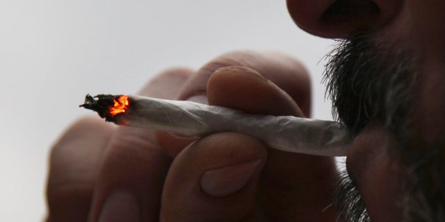 In this Aug. 4, 2013 photo, a man identified only as Pedro smokes a marijuana cigarette at his home in Mexico City. A group of leftist Mexico City lawmakers have introduced a bill, Thursday Feb 13, 2014, to legalize the sale of marijuana in the nation's capital. Since 2009, Mexico has allowed the possession of 5 grams of marijuana, about four joints, for personal use. (AP)