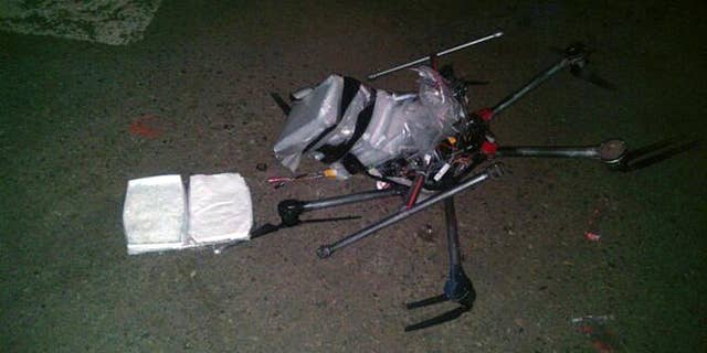 In this image released by the Tijuana Municipal Police on Wednesday Jan. 21, 2015, a drone loaded with packages containing methamphetamine lies on the ground after it crashed into a supermarket parking lot in the city of Tijuana on Tuesday Jan. 20, 2015. According to police, six packets of the drug, weighing more than six pounds, were taped to the six-propeller remote-controlled aircraft. Authorities are investigating where the flight originated and who was controlling it. He said it was not the first time they had seen drones used for smuggling drugs across the border. Other innovative efforts have included catapults, ultralight aircraft and tunnels. (AP Photo/Secretaria de Seguridad Pública Municipal de Tijuana)
