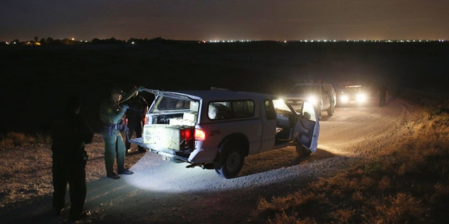 HIDALGO, TX - APRIL 10: A U.S. Border Patrol Agent inspects a pickup truckload of marijuana seized from drug smugglers near the U.S.-Mexico border on April 10, 2013 in Hidalgo, Texas. The agents, guided by helicopter surveillance from the U.S. Office of Air and Marine, waited more than four hours in hiding before seizing more than 900 pounds of the drug. The smugglers ran and escaped by swimming back across the Rio Grande River into Mexico. Border Patrol agents say they have also seen an additional surge in immigrant traffic since immigration reform negotiations began this year in Washington D.C. Proposed refoms could provide a path to citizenship for many of the estimated 11 million undocumented workers living in the United States. (Photo by John Moore/Getty Images)