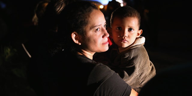 MISSION, TX - SEPTEMBER 08: Families of Central American immigrants, including Jamie Gonzales, 26, and her son Jose Manuel, 4, from El Salvador, turn themselves in to U.S. Border Patrol agents after crossing the Rio Grande River from Mexico on September 8, 2014 to Mission, Texas. Although the numbers of such immigrant families and unaccompanied minors have decreased from a springtime high, thousands continue to cross in the border illegally into the United States. The Rio Grande Valley sector is the busiest area for illegal border crossings, especially for Central Americans, into the U.S. (Photo by John Moore/Getty Images)