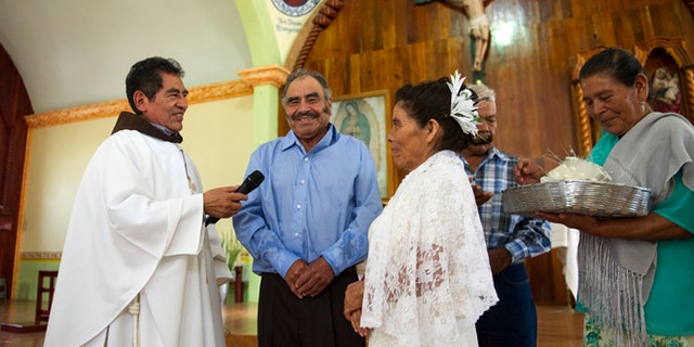 Francisca Santiago, 65, and Pablo Ibarra, 75, exchange wedding vows on July 23, 2016.