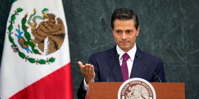 FILE - In this Aug. 27, 2015 file photo, Mexico's President Enrique Pena Nieto speaks during a press conference to announce cabinet changes, at the Los Pinos presidential residence, in Mexico City. Pena Nieto is set to deliver his third state-of-the-nation address on Wednesday, Sept. 2, 2015, amid rising violence, a falling currency and a slowing economy. Pena Nieto shook up his cabinet last week in an apparent attempt to change direction. But tough international market conditions may limit his maneuvering room. (AP Photo/Rebecca Blackwell, File)