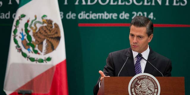 Mexican President Enrique Pena Nieto speaks during a signing ceremony for a new law that further protects children at Los Pinos presidential residence in Mexico City, Wednesday, Dec. 3, 2014. (AP Photo/Eduardo Verdugo)