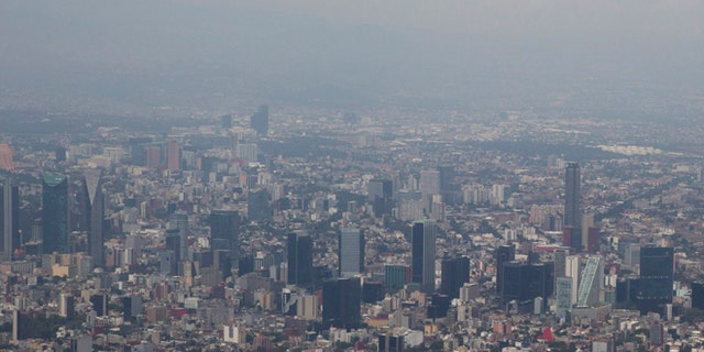 FILE - In this March 18, 2016, file photo, view shows Mexico City covered in smog a day after a pollution alert was lifted. Mexico City authorities have declared a pollution alert on Monday, May 2, 2016, after smog rose to 1½ times acceptable limits for second time in less than a month. (AP Photo/Rebecca Blackwell, File)