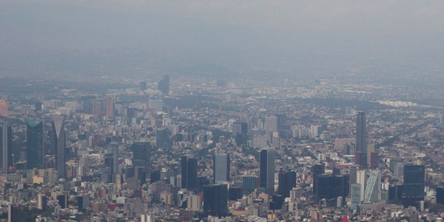 FILE - In this March 18, 2016, file photo, view shows Mexico City covered in smog a day after a pollution alert was lifted. Mexico City authorities have declared a pollution alert on Monday, May 2, 2016, after smog rose to 1½ times acceptable limits for second time in less than a month. (AP Photo/Rebecca Blackwell, File)