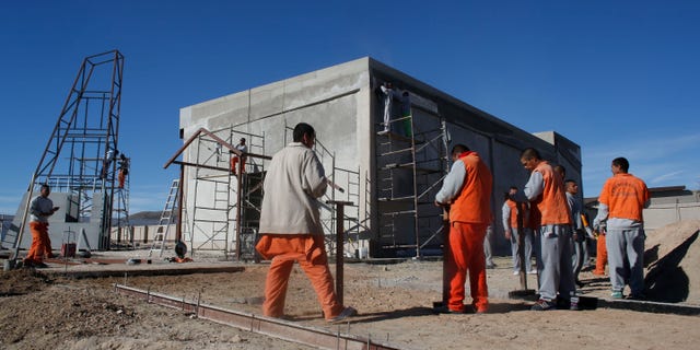 Inmates work construction inside the state prison in Ciudad Juarez, Sunday, Jan. 17, 2016.