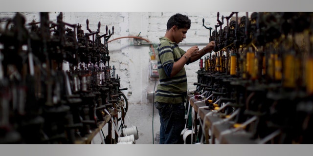 In this Feb. 29, 2012 photo, a worker uses a threading machine at the sombrero shop of Maria de la Luz Yepez, not shown, who is preparing three Mexican style sombreros to give as gifts to Pope Benedict XVI, in the town of San Francisco del Rincon, near Leon, Mexico. The visit of Pope Benedict XVI, his first to Spanish-speaking Latin America, begins on March 23 in Mexico's central state of Guanajuato, where he will spend three days and give an outdoor Mass before heading to Cuba on March 26. (AP Photo/Dario Lopez-Mills)
