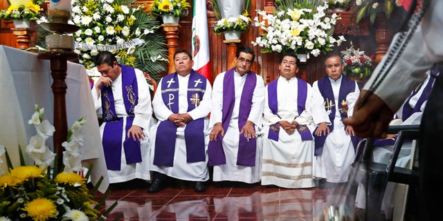 Priests attend the funeral Mass for slain Rev. Jose Alfredo Suarez in Paso Blanco, Veracruz, Mexico, Sept. 21, 2016.