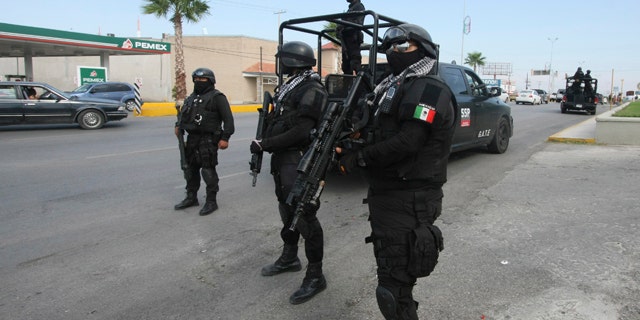 Rapid response Coahuila state police stand at a checkpoint in the city of Piedras Negras, Mexico.