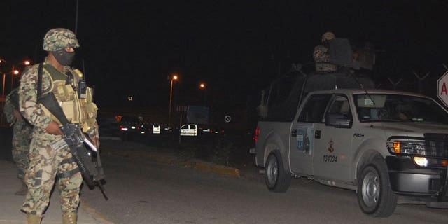 January 4, 2012: Soldiers stand guard outside a prison after a fight between rival gangs in Altamira, Tamaulipas. A fight between rival gangs inside the prison in northern Mexico left 31 inmates dead.