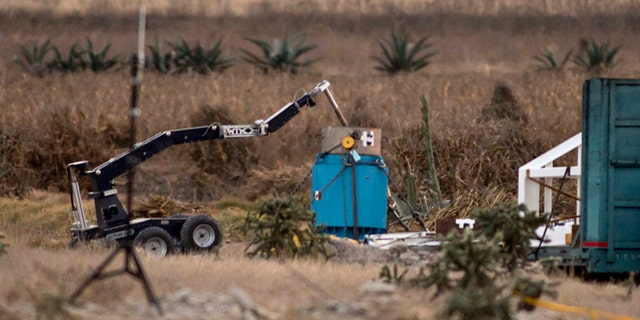 A robotic arm recovers radioactive cobalt-60 and deposits it in a safe container on a field in the town of Hueypoxtla, central Mexico, Tuesday Dec. 10, 2013.