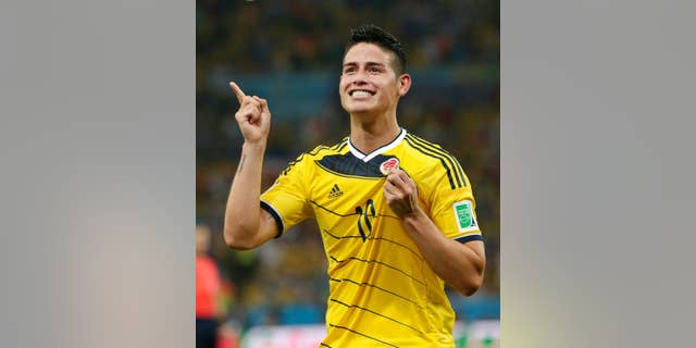 FILE - In this June 28, 2014, file photo, Colombia's James Rodriguez celebrates after he scored his side's second goal during the World Cup round of 16 soccer match between Colombia and Uruguay at the Maracana Stadium in Rio de Janeiro, Brazil. The 23-year-old Monaco forward who was the top scorer at the World Cup, is closing in on a deal with Real Madrid. Spanish sports newspapers said Monday that Monaco had agreed terms with Madrid and Rodriguez is to be presented to fans on Tuesday. (AP Photo/Marcio Jose Sanchez,File)