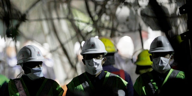 Employees cull through debris searching for office documents amid the rubble left from an office building explosion in Mexico City, Feb. 2. The death toll is now at 37.