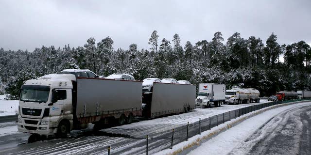 Traffic stands still due to snow, in Rio Frio, Mexico, Thursday, March 12, 2015. One of the main access roads to the city of Mexico was closed on Thursday after a snowstorm in the mountainous area east of the capital which reached unusual levels. (AP Photo)