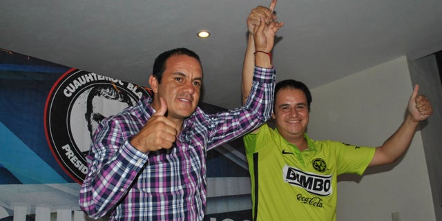 Cuauhtemoc Blanco, left, gives the thumbs up during election day Sunday, June 7, 2015.
