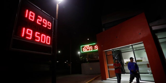 A currency exchange business displays rates of the Mexican peso Tuesday, Nov. 8, 2016, in Tijuana, Mexico.