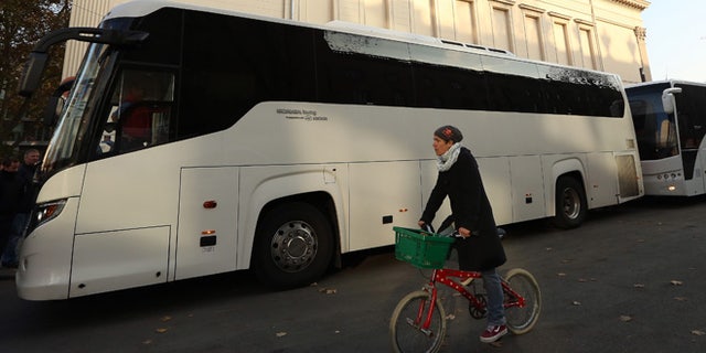 BERLIN, GERMANY - NOVEMBER 07: Two buses full of activists traveling from Berlin to the Mediterranean to 'Tear down the European Wall,' or cut down portions of the European Union's border fence, prepare to depart from outside the Gorki Theater on November 7, 2014 in Berlin, Germany. Amidst ongoing celebrations for the 25th anniversary of the Fall of the Berlin Wall, activists from the group Center for Political Beauty (CPB, or Zentrum fuer Politische Schoenheit, ZPS, in German) claim to have removed 14 white crosses from the city center placed in memory of some of the victims killed trying to cross from East to West Berlin during the Cold War, a protest designed to call attention to the activists' perceived hypocrisy found in fortifying the border preventing entry for refugees into Europe while celebrating the fall of the notorious one in Berlin a quarter of a century ago. The artist collective claims to have given the crosses to refugees from Mali hiding in the forests of Mount Gurugu in northern Morocco who are trying to cross into Melilla, one of two Spanish enclaves in the region, for passage into Europe. (Photo by Adam Berry/Getty Images)