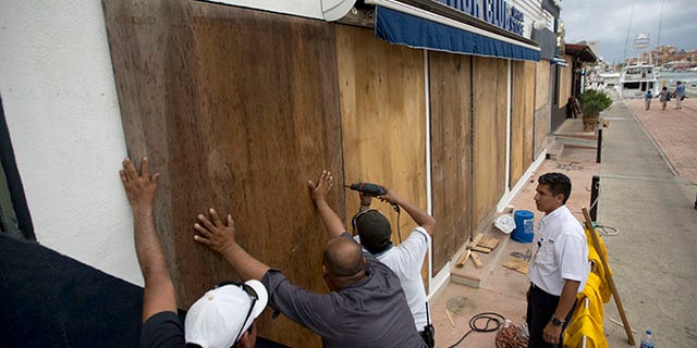 Workers board over a store front in preparation for Hurricane Newton, in Cabo San Lucas, Mexico, Monday Sept. 5, 2016. Authorities at the southern end of Mexico's Baja California peninsula ordered schools closed and set up emergency shelters as Hurricane Newton gained strength while bearing down on the twin resorts of Los Cabos for a predicted arrival Tuesday morning. (AP Photo/Eduardo Verdugo)