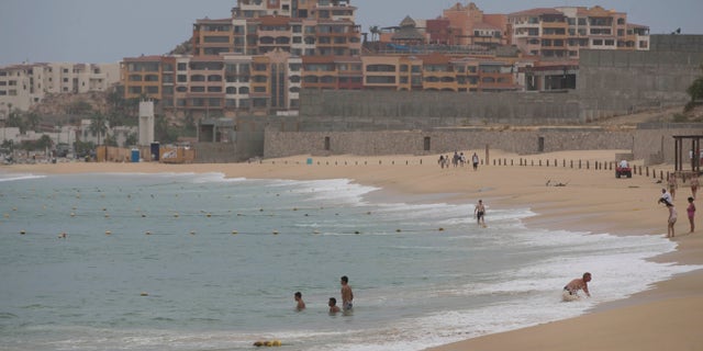 People wade in the waters of El Medano Beach before the arrival of Hurricane Blanca, in Cabo San Lucas, Mexico, Saturday, June 6, 2015. The unpredictable Blanca, which strengthened suddenly from a Category 1 to a Category 4 storm on Saturday before weakening slightly, is expected to make landfall as a tropical storm on Monday. But authorities said its outer bands could start hitting the southern Baja California Peninsula as a hurricane on Sunday. (AP Photo/Eduardo Verdugo)
