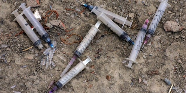 KABUL, AFGHANISTAN - AUGUST 20: Used needles litter the ground outside an abandoned building where many addicts live August 20, 2007 in Kabul, Afghanistan. Fearing an AIDS outbreak many clinics are handing out clean needles instructing the addicts to not resuse them.. The cost for daily use is around $3.00 USD or 150 Afghan currency. Although there are around 35,000 NATO troops in Afghanistan, the drug trade has increased, with Afghanistan producing 95 percent of the world's poppies. According to the UN Office on Drugs and Crime (UNODC), the opium production in 2006 increased 57 percent from 2005, with an additional 15% jump in 2007. (Photo Paula Bronstein/Getty Images)