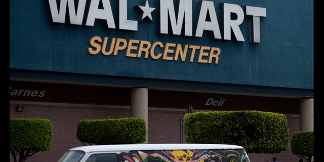April 21, 2012: A van covered by a mural sits parked outside a Walt-Mart Super Center in Mexico City.