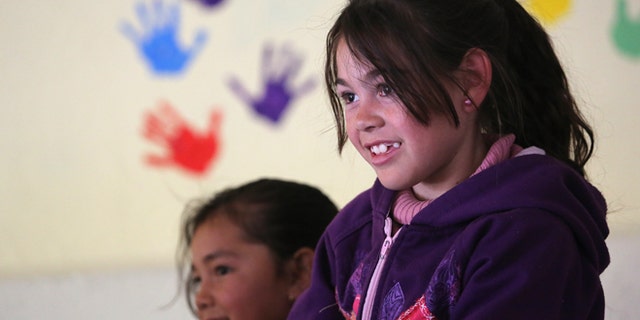 Children receive a free lunch at the Home of Hope and Peace kitchen on March 5, 2013 in Nogales, Mexico.