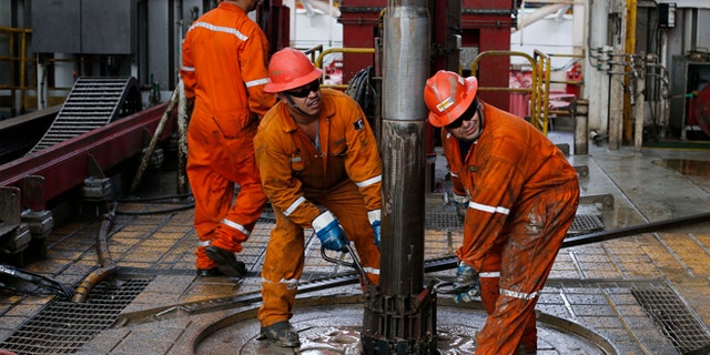 FILE - In this Nov. 22, 2013, file photo, oil workers set the drill on the Centenario deep-water drilling platform off the coast of Veracruz, Mexico in the Gulf of Mexico. The lowest oil prices in nearly six years couldn't have come at a worse time for Mexico, which last year opened up oil-sector investment to private companies for the first time in decades. Slumping oil prices have forced Mexico to slash its 2015 budget with most of the cutbacks expected to come in the energy sector. Analysts predict bids on energy partnerships made possible by Mexicoâs historic reform will be lower than anticipated (AP Photo/Dario Lopez-Mills, File)