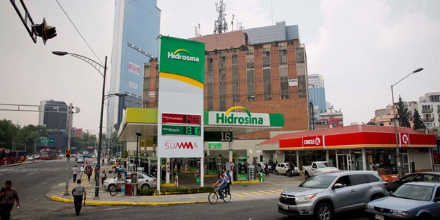 Hidrosina opened a re-branded Pemex gas station on one of the main avenues in Mexico City, Tuesday, June 7, 2016. Mexico's ubiquitous Pemex gas stations now have competition along the country's highways and city streets for the first time in nearly eight decades. Two companies have collectively opened three gas stations under their own brands, breaking one of the state-owned petroleum company's last monopolies. Opening the retail sector to competition was part of energy reforms passed in 2014. (AP Photo/Eduardo Verdugo)