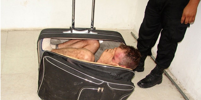 July 2: Inmate Juan Ramirez Tijerina inside a suitcase after he tried to escape from prison with the help of his girlfriend following a conjugal visit in Chetumal, Mexico.