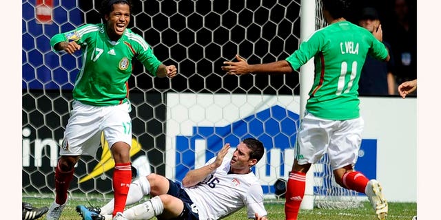 EAST RUTHERFORD, NJ - JULY 26: Giovani Dos Santos #17 and Carlos Vela #11 of Mexico celebrate Dos Santos' goal in front of Jay Heaps #16 of the United States in the CONCACAF Gold Cup Championship match at Giants Stadium on July 26, 2009 in East Rutherford, New Jersey. (Photo by Jeff Zelevansky/Getty Images)