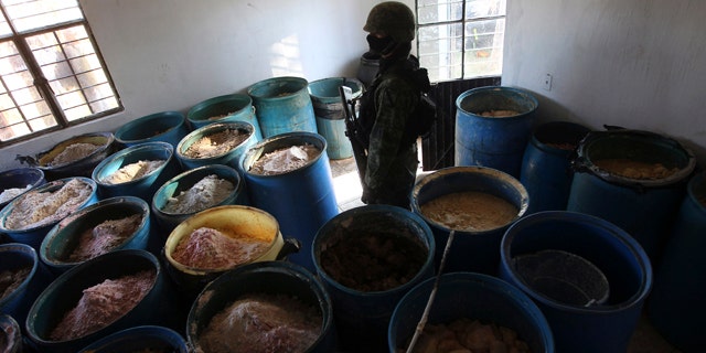 Feb. 9, 2012- A soldier stands in a room full of barrels containing white and yellow powder after a seizure of a small ranch in Tlajomulco de Zuniga, on the outskirts of Guadalajara, Mexico. According to the Mexican army, 15 tons of pure methamphetamine were seized at the ranch, an amount equivalent to half of all meth seizures worldwide in 2009.