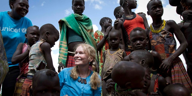 July 15: UNICEF Goodwill Ambassador, US actress Mia Farrow with a group of Karimojong children at a Tokul near the town of Kitodo, in the far north west of Uganda. (AP)