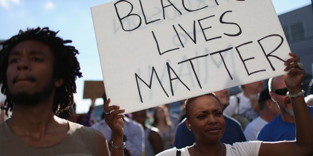 MIAMI, FL - DECEMBER 07: Demonstrators march through the Wynwood neighborhood as they protest police abuse on December 7, 2014 in Miami, Florida. The protest was one of many that have take place nationwide after grand juries investigating the deaths of Michal Brown in Ferguson, Missouri and Eric Garner in New York failed to indict the police officers involved in both incidents (Photo by Joe Raedle/Getty Images)