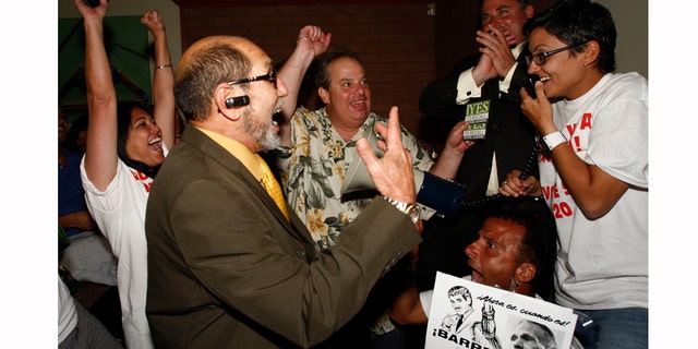 Members of Miami Voice and Miami Lakes Mayor Michael Pizzi, join Mimi Planas, left, Ernesto Lopez, Kevin Moejon, Ernesto Hernandez, holding the sign, Vanessa Brito, right, as they celebrate the results recalling County Commissioner Natacha Seijas and Miami Mayor Carlos Alvarez on Tuesday, March 15, 2011, inside the Billiard Club in Miami Lakes, Fla. (AP Photo/The Miami Herald, Carl Juste) MAGS OUT