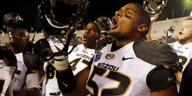 FILE - In this Sept. 21, 2013, file photo, Missouri's Michael Sam (52) sings the school song after Missouri defeated Indiana in an NCAA college football game in Bloomington, Ind. The All-American athlete says he is gay, and the defensive end could become the first openly homosexual player in the NFL. (AP Photo/Darron Cummings, File)