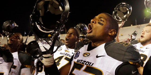 FILE - In this Sept. 21, 2013, file photo, Missouri's Michael Sam (52) sings the school song after Missouri defeated Indiana in an NCAA college football game in Bloomington, Ind. The All-American athlete says he is gay, and the defensive end could become the first openly homosexual player in the NFL. (AP Photo/Darron Cummings, File)
