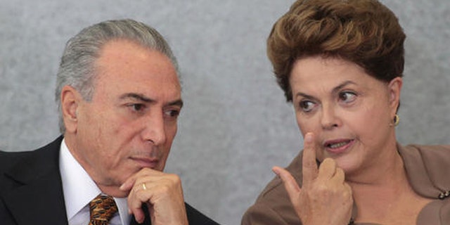 FILE - In this April 24, 2012 file photo, Brazil's President Dilma Rousseff, right, talks with Vice President Michel Temer, during a ceremony at Planalto Palace in Brasilia, Brazil. Three ministers in the government of interim President Temer, who took over when Rousseff was suspended in May, were forced to resign right after taking office because of corruption allegations. And Temer himself has been fingered for bribery by witnesses in the Petrobras investigation who have reached plea deals with prosecutors, though so far he has not been charged. (AP Photo/Eraldo Peres)