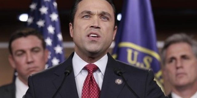 FILE: Rep. Michael Grimm, R-N.Y., center, accompanied by Rep. Duncan Hunter, R-Calif., left, House Majority Whip Kevin McCarthy of Calif., speaks during a news conference on Capitol Hill.