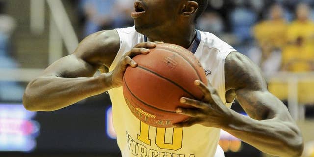 FILE - In this Nov. 21, 2013 file photo, West Virginia's Eron Harris (10) looks to pass during the second half of an NCAA college basketball game against Georgia Southern in Morgantown, W.Va. High-scoring guard Eron Harris is transferring to Michigan State from West Virginia. His father, Eric Harris, says Monday, June 9, 2013, that offers were turned down from Michigan, Wisconsin, Purdue and UCLA. (AP Photo/Andrew Ferguson, File)