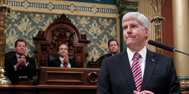 Senate Majority Leader Randy Richardville, R-Monroe, from left, Lt. Gov. Brian Calley, and House Speaker Jase Bolger, R-Marshall, applaud as Michigan Gov. Rick Snyder, right, delivers his State of the State address to a joint session of the House and Senate, Thursday, Jan. 16, 2014, in the House Chambers of the state Capitol in Lansing, Mich. (AP Photo/Al Goldis)