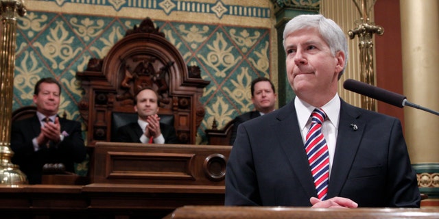 Senate Majority Leader Randy Richardville, R-Monroe, from left, Lt. Gov. Brian Calley, and House Speaker Jase Bolger, R-Marshall, applaud as Michigan Gov. Rick Snyder, right, delivers his State of the State address to a joint session of the House and Senate, Thursday, Jan. 16, 2014, in the House Chambers of the state Capitol in Lansing, Mich. (AP Photo/Al Goldis)